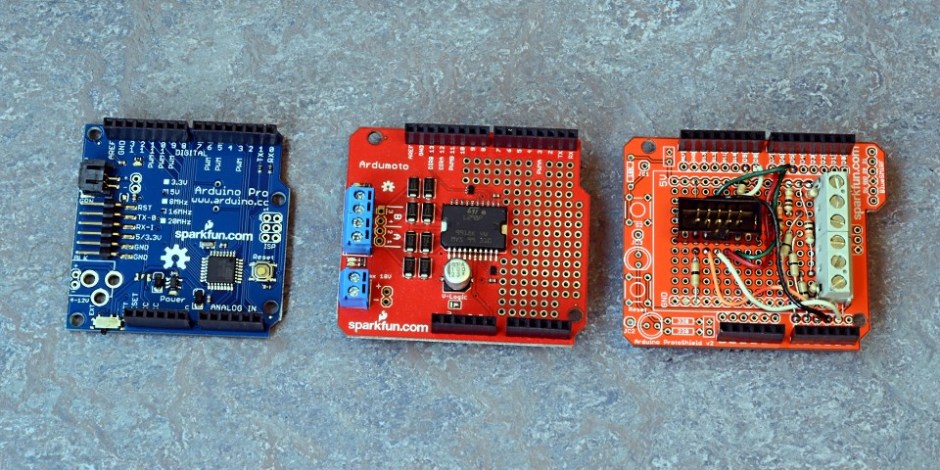 L to R: Arduino Pro microcontroller, Sparkfun Ardumoto board with L298 motor controller, protoboard with connectors for front-panel board and layout IR sensors. 
