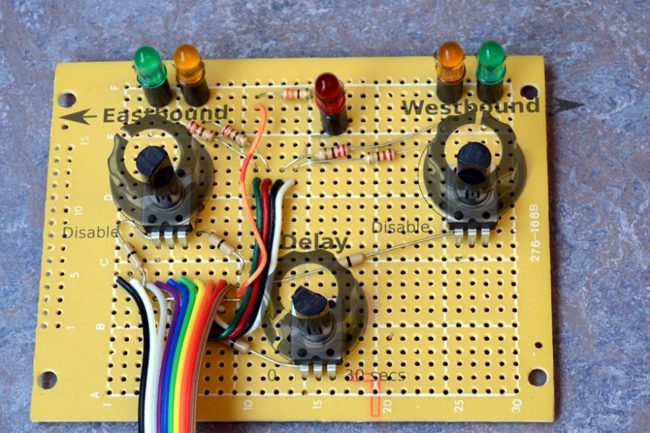 Front-panel board, with LEDs and potentiometers installed. Mockup of front-panel design and knobs are "ghosted" on. 